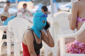 Women balaclava style face masks at a beach, Qingdao, Shandong Province, China - 14 Aug 2014